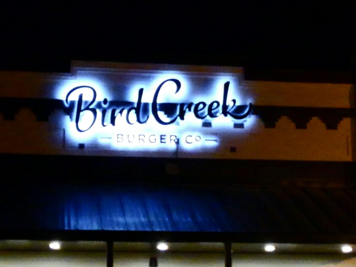 Illuminated channel letter storefront sign lit at night